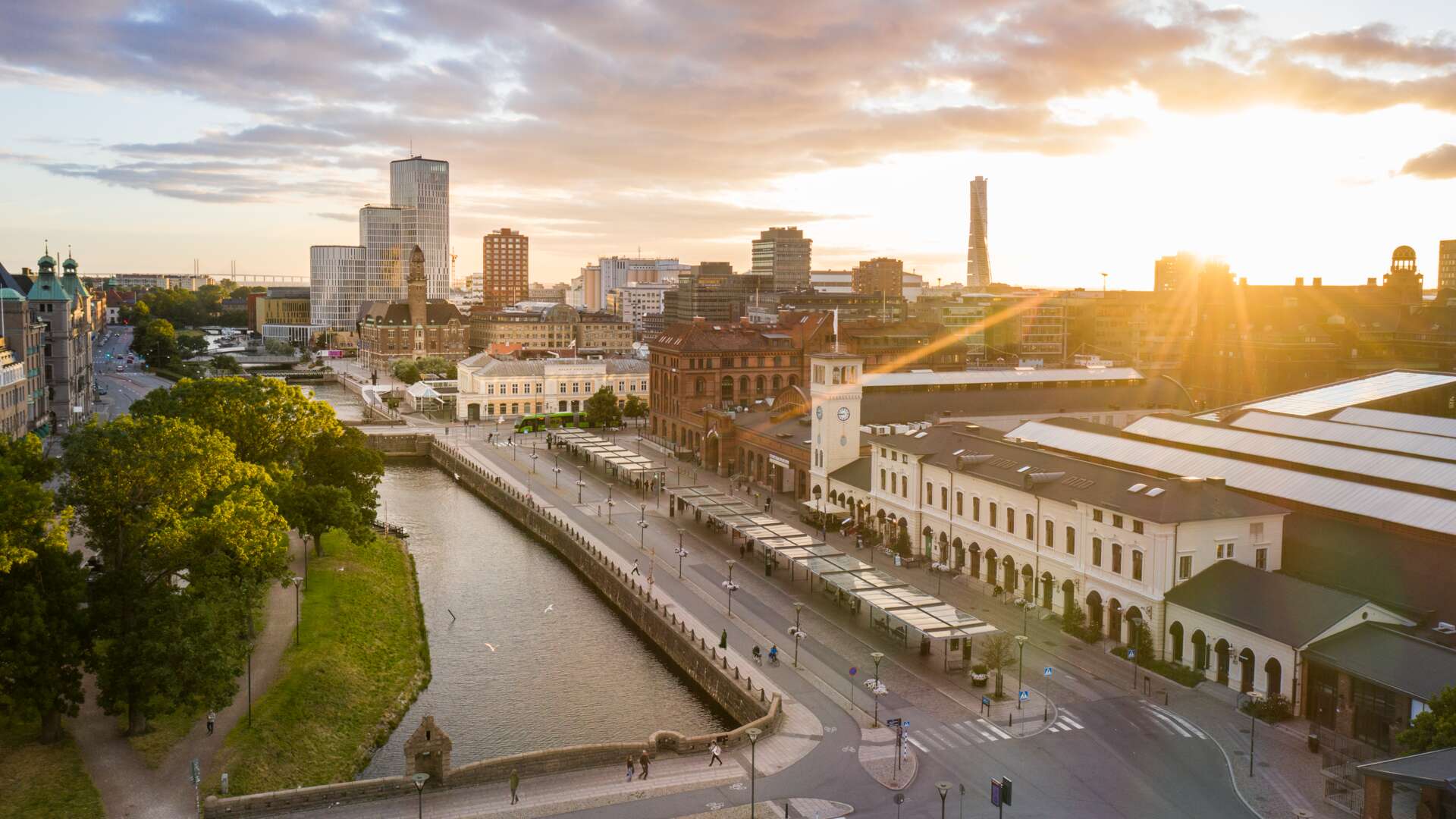 A view of the canal in Malmö, with sunshine above the buildings.